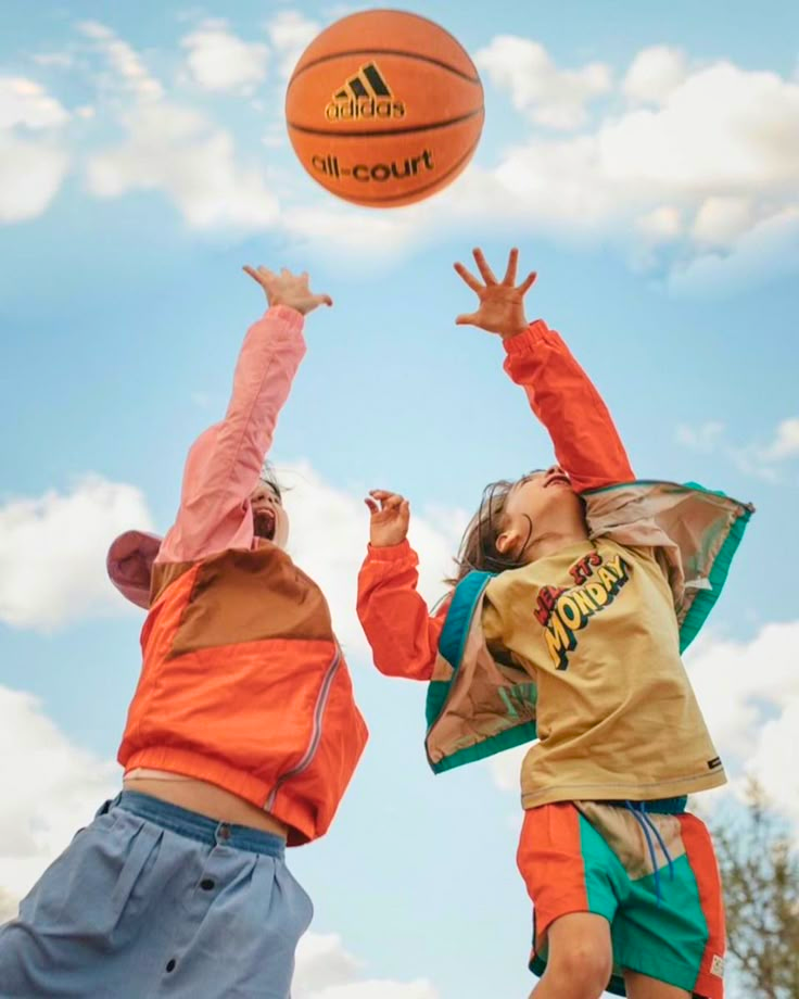 Kids jumping for a basketball