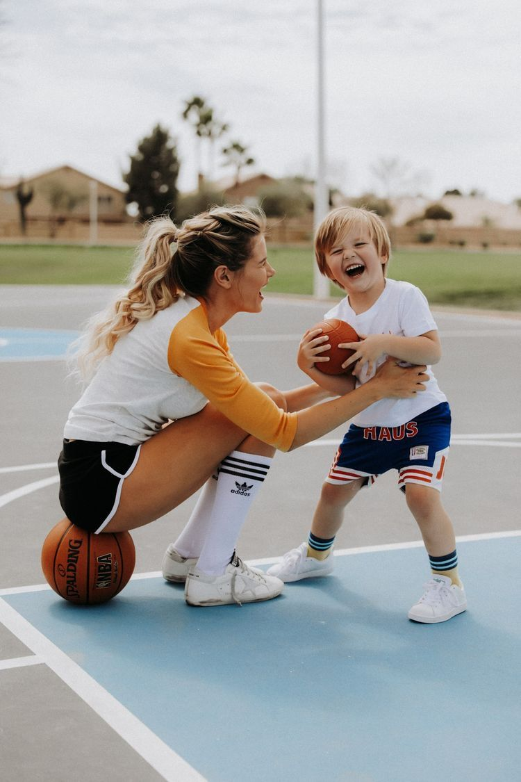 A parent and child playing basketball